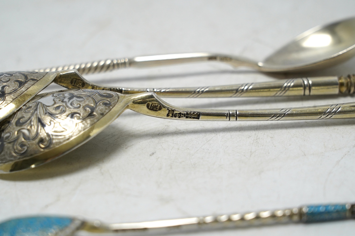 A pair of 19th century Russian 84 zolotnik and niello spoons, 15.5cm and two other Russian spoons including small spoon with cloisonné enamel. Condition - poor to fair